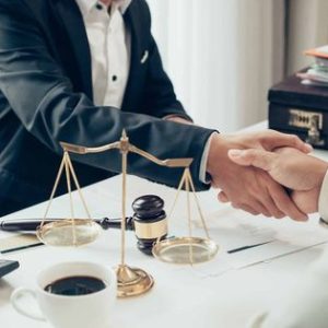 Businessman shaking hands to seal a deal with his partner lawyers or attorneys discussing a contract agreement